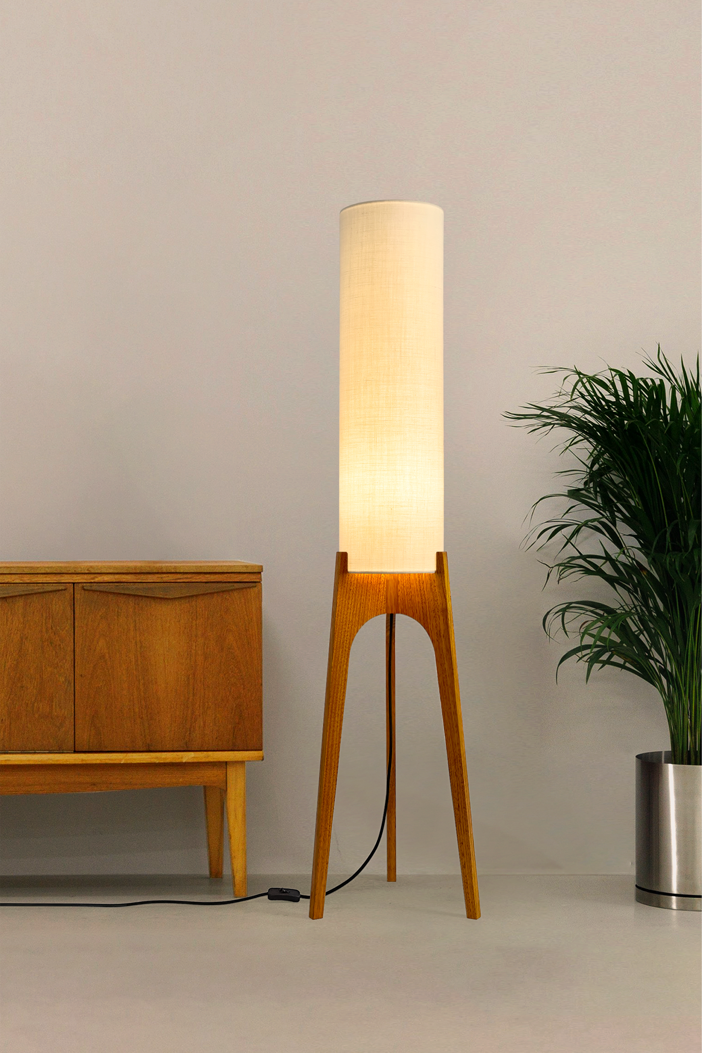 Cotton – Premium Linen Archie Rocket Floor Lamp with a beige shade next to a wooden cabinet and plant on a neutral background. Clean, airy, and effortlessly versatile, its soft tone brings calm and clarity to any space.