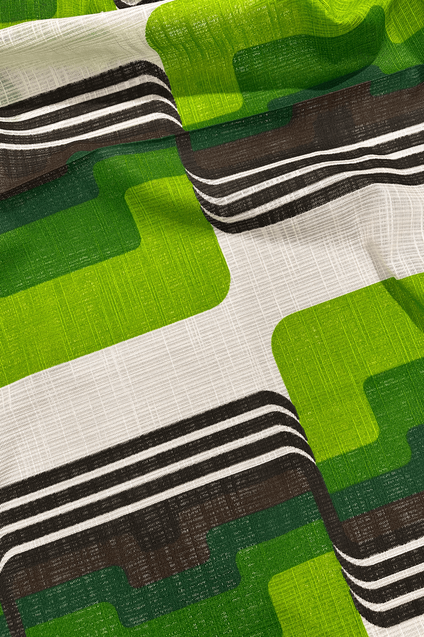 Close-up of fabric with green, brown, and white geometric pattern