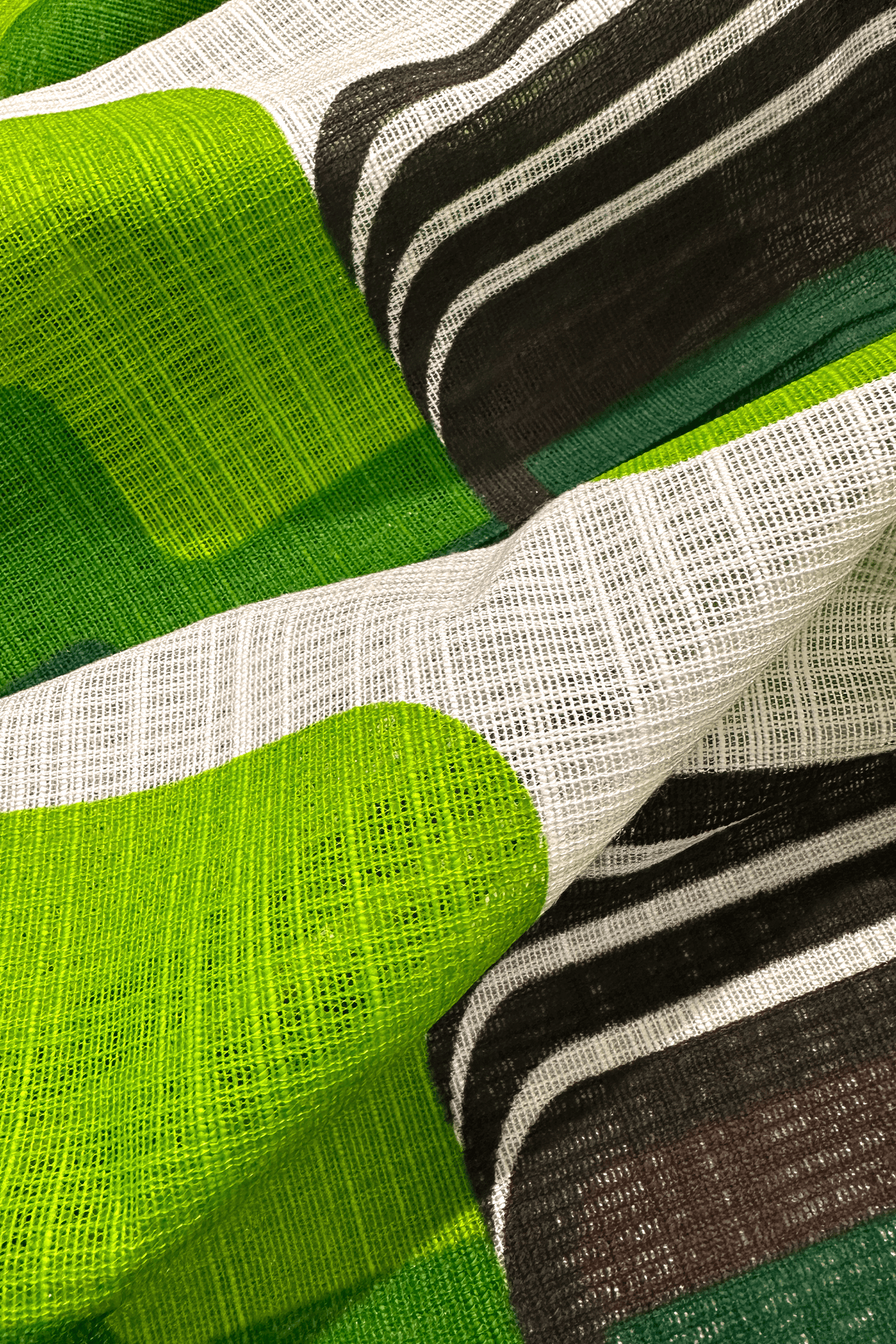Close-up of fabric with green, black, and white pattern
