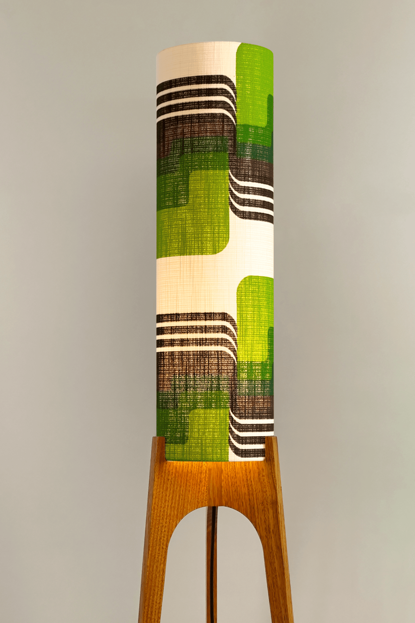 Fern - Archie Rocket floor lamp with handmade wooden base and handcrafted lampshade from vintage fabric with retro geometric patterns in green, brown, and white.