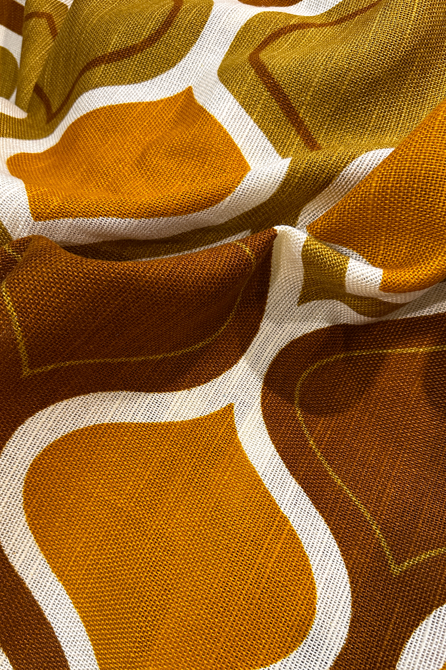 Patterned fabric with brown and orange geometric design on a brown background