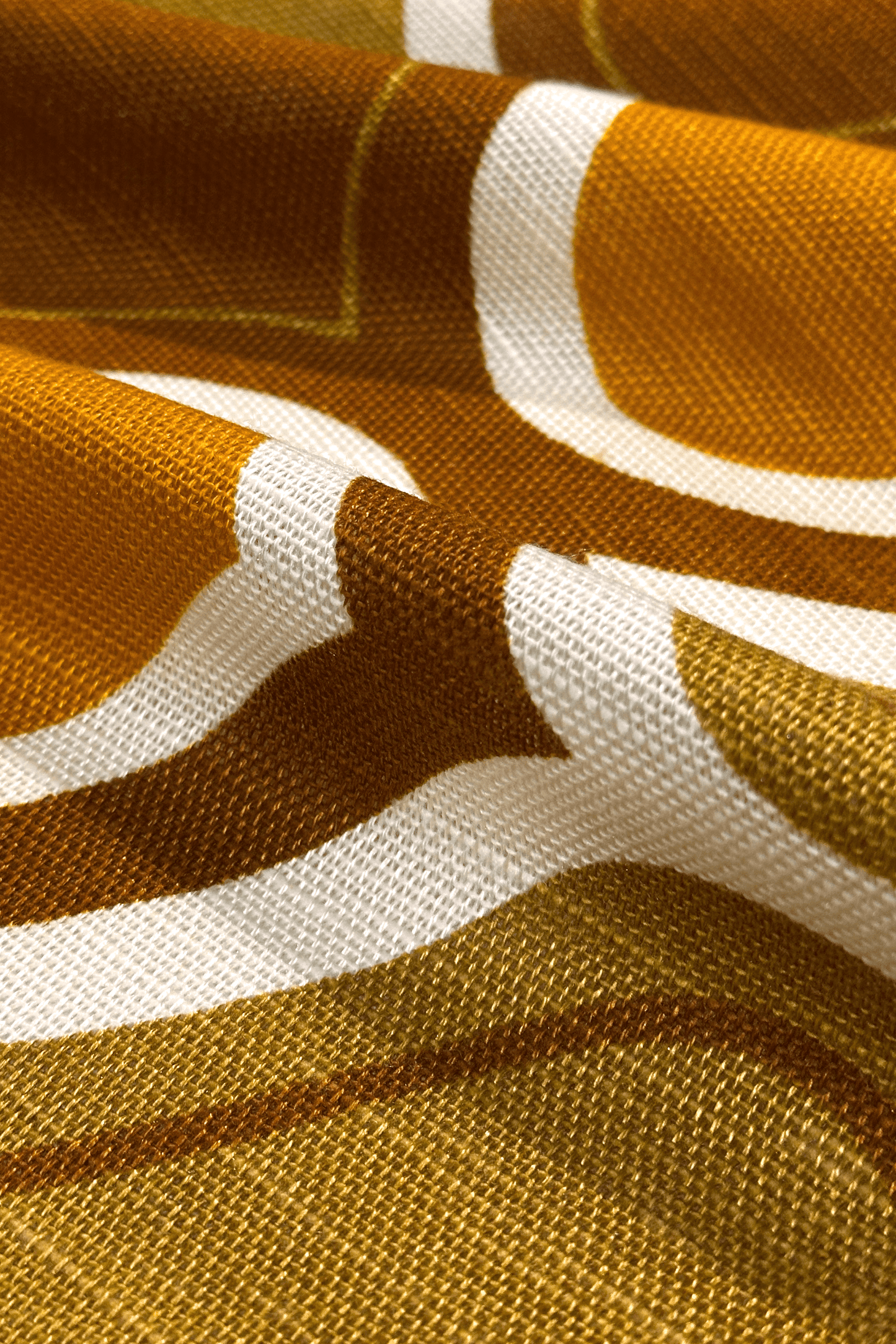 Close-up of fabric with mustard and brown geometric pattern