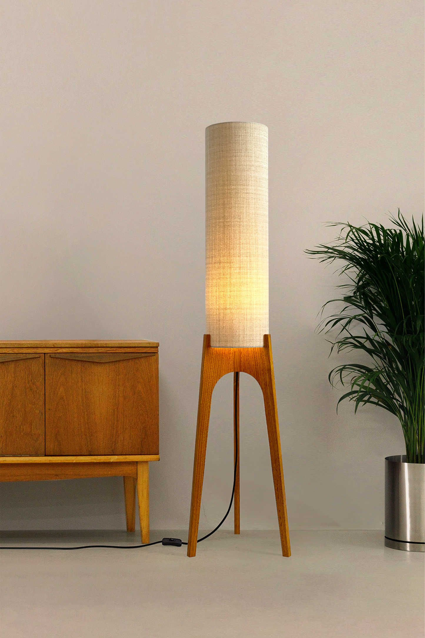 Ivory - Archie Rocket Floor Lamp handmade by Retro Duo. A soft, natural and timeless wooden floor lamp with a cylindrical shade in a room with a cabinet and a plant.