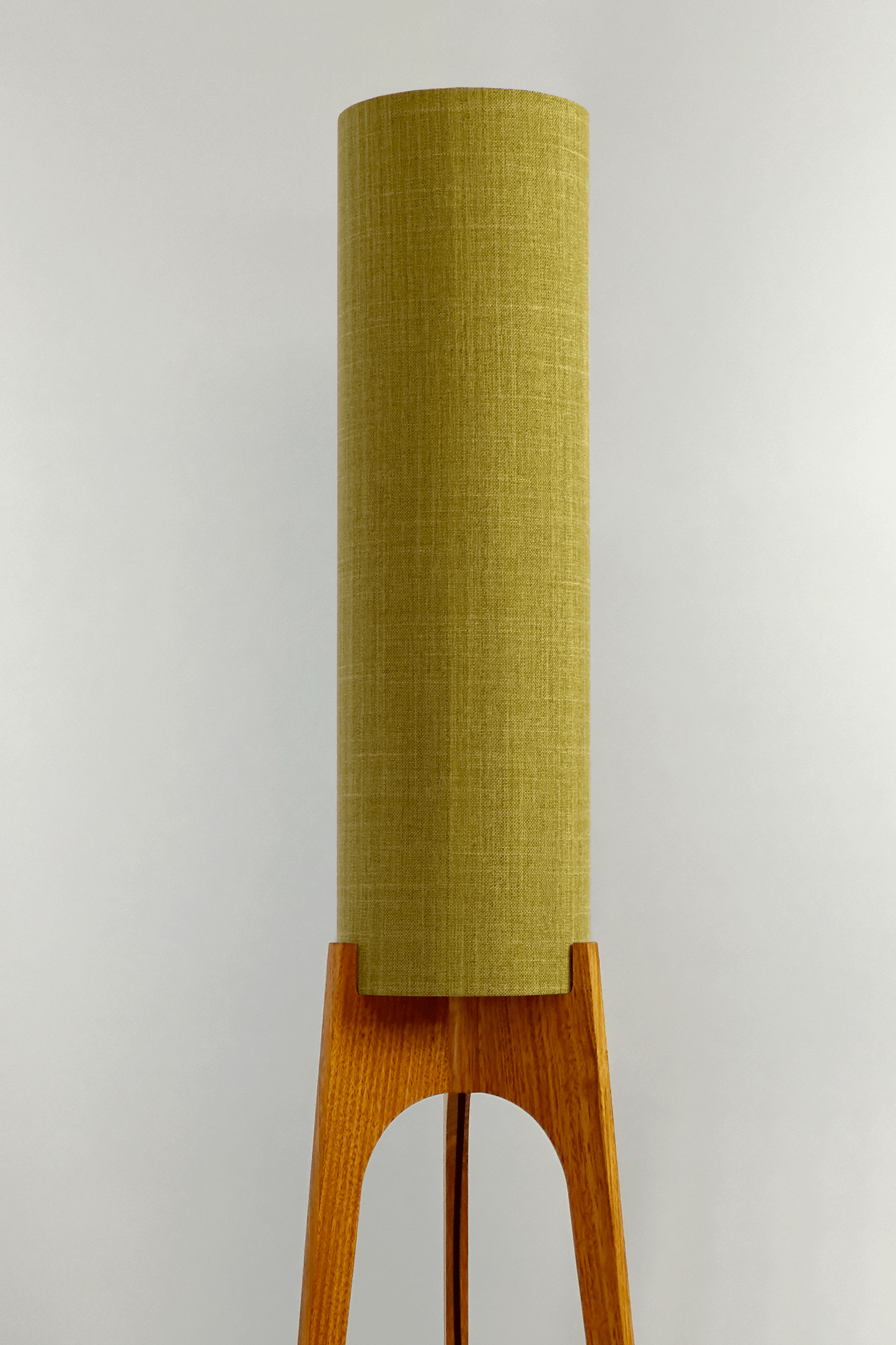 Archie Rocket Floor Lamp with lemongrass cylindrical shade on a wooden base against a white background