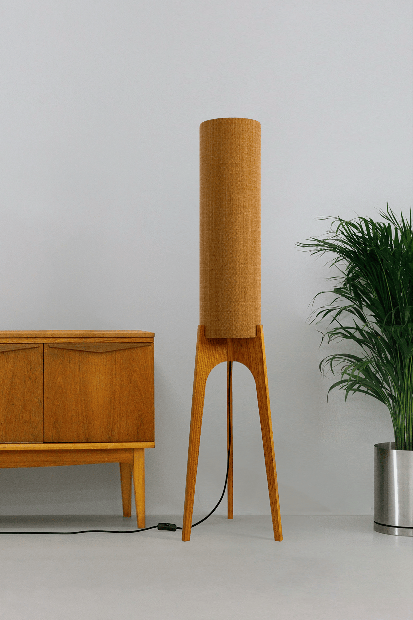 Mustard. Archie Rocket Floor Lamp - a handcrafted wooden floor lamp with a cylindrical shade in a mustard colour in a minimalist room.
