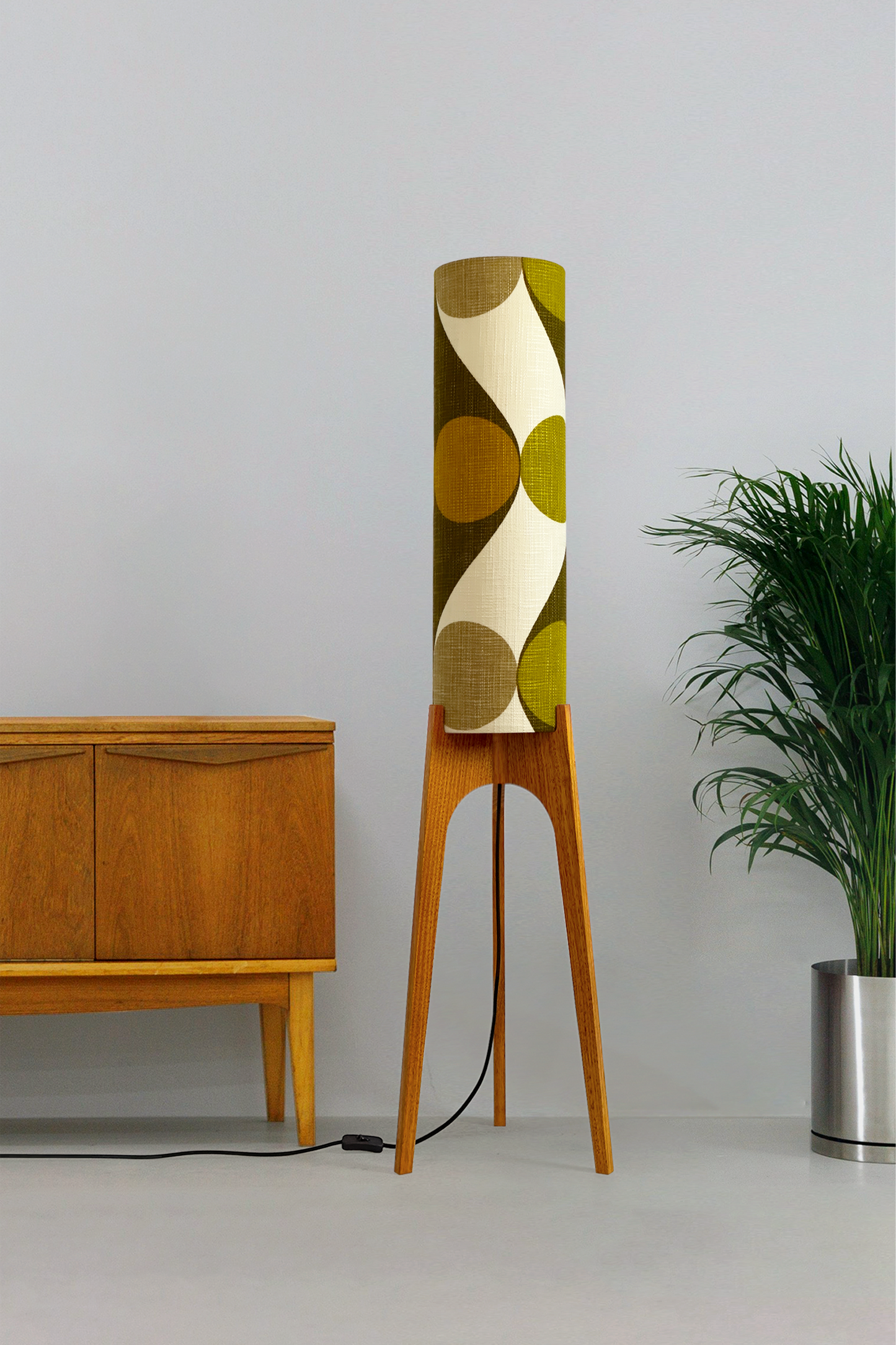 Olli - Archie Rocket Floor Lamp handmade by Retro Duo, from vintage geometric patterned fabric lampshade and wooden lamp base in a room with a wooden cabinet and plant.