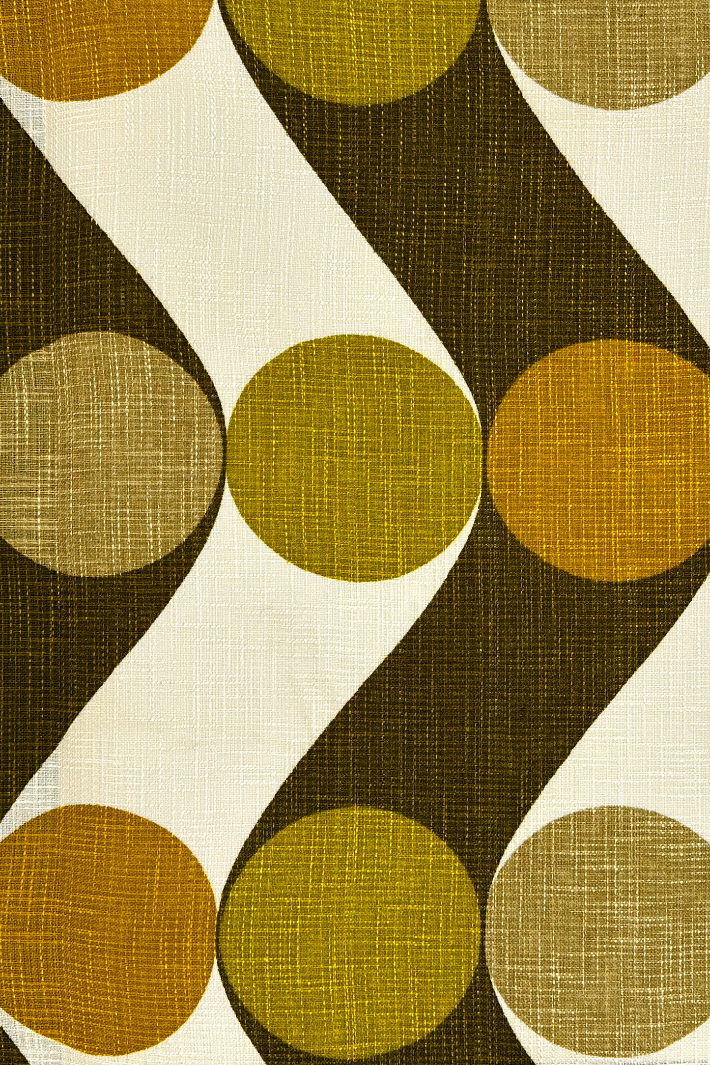 Patterned fabric with olive, mustard and brown circles on a white background