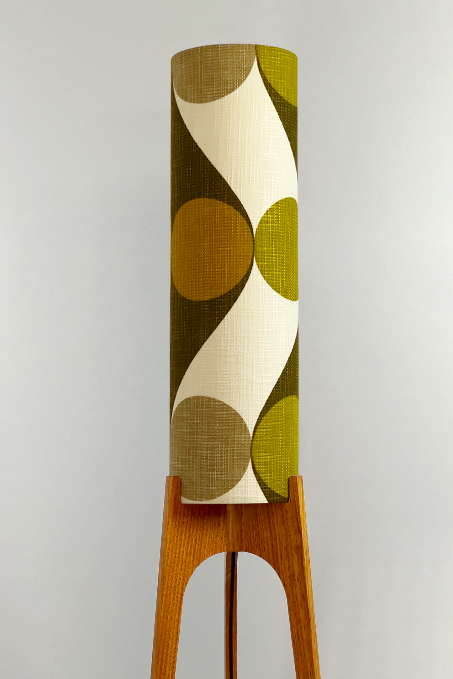 Olli - Archie Rocket Floor Lamp handmade by Retro Duo, from vintage geometric patterned fabric lampshade and wooden lamp base in a room with a wooden cabinet and plant.