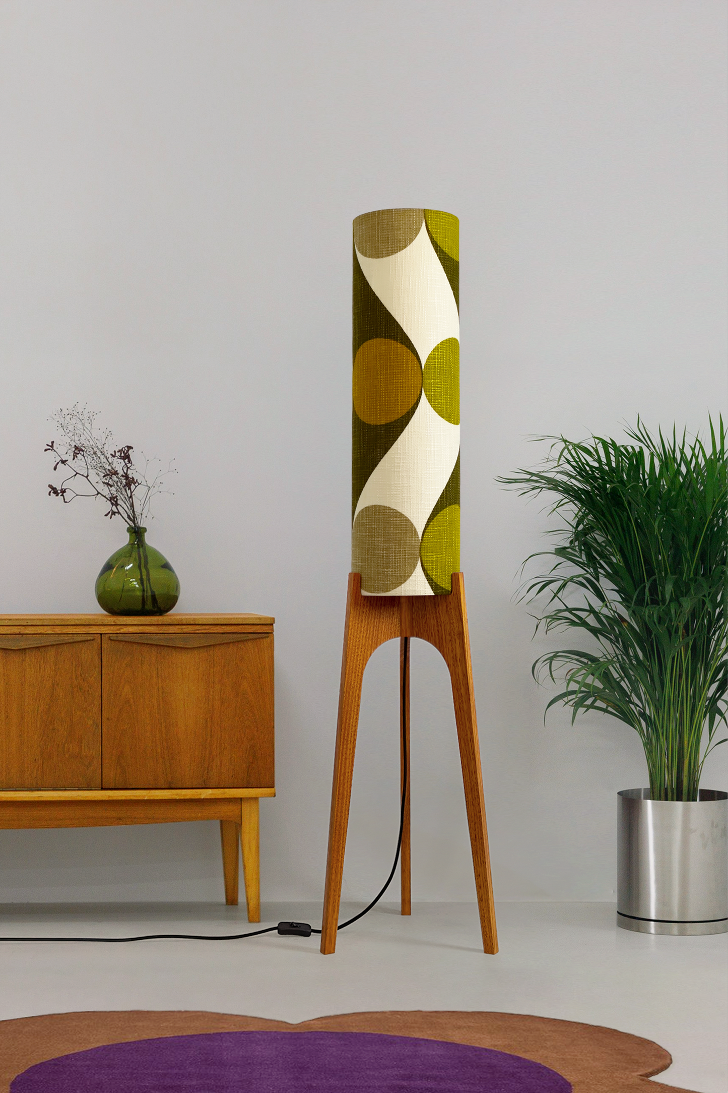 Olli - Archie Rocket Floor Lamp handmade by Retro Duo, from vintage geometric patterned fabric lampshade and wooden lamp base in a room with a wooden cabinet and plant.