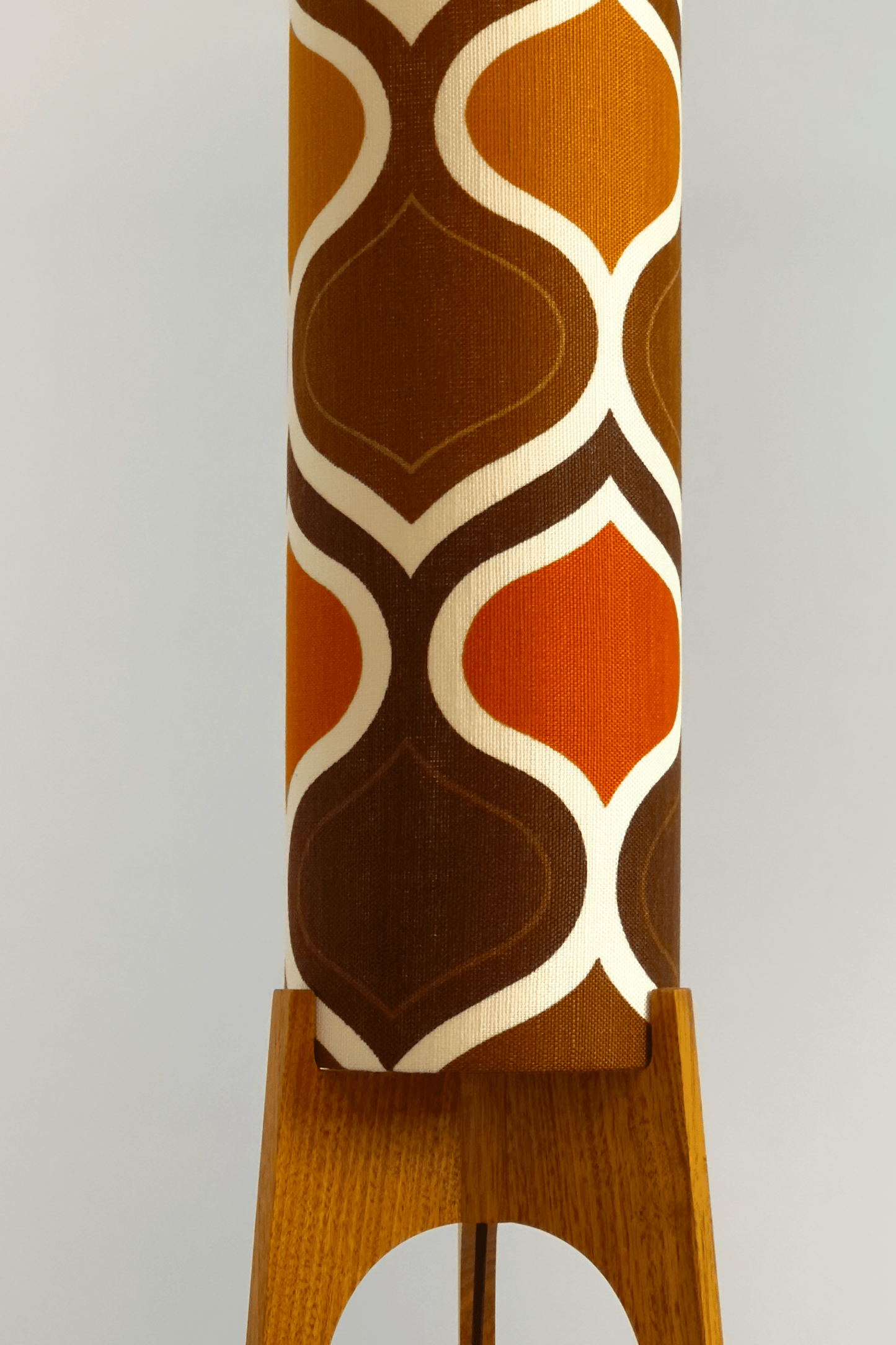 The Tangerine Archie Rocket Floor Lamp is a playful nod to the geometric patterns of the 1970s. Handcrafted from authentic vintage fabric and hardwood oak with a patterned shade in Mustard, Brown and Olive