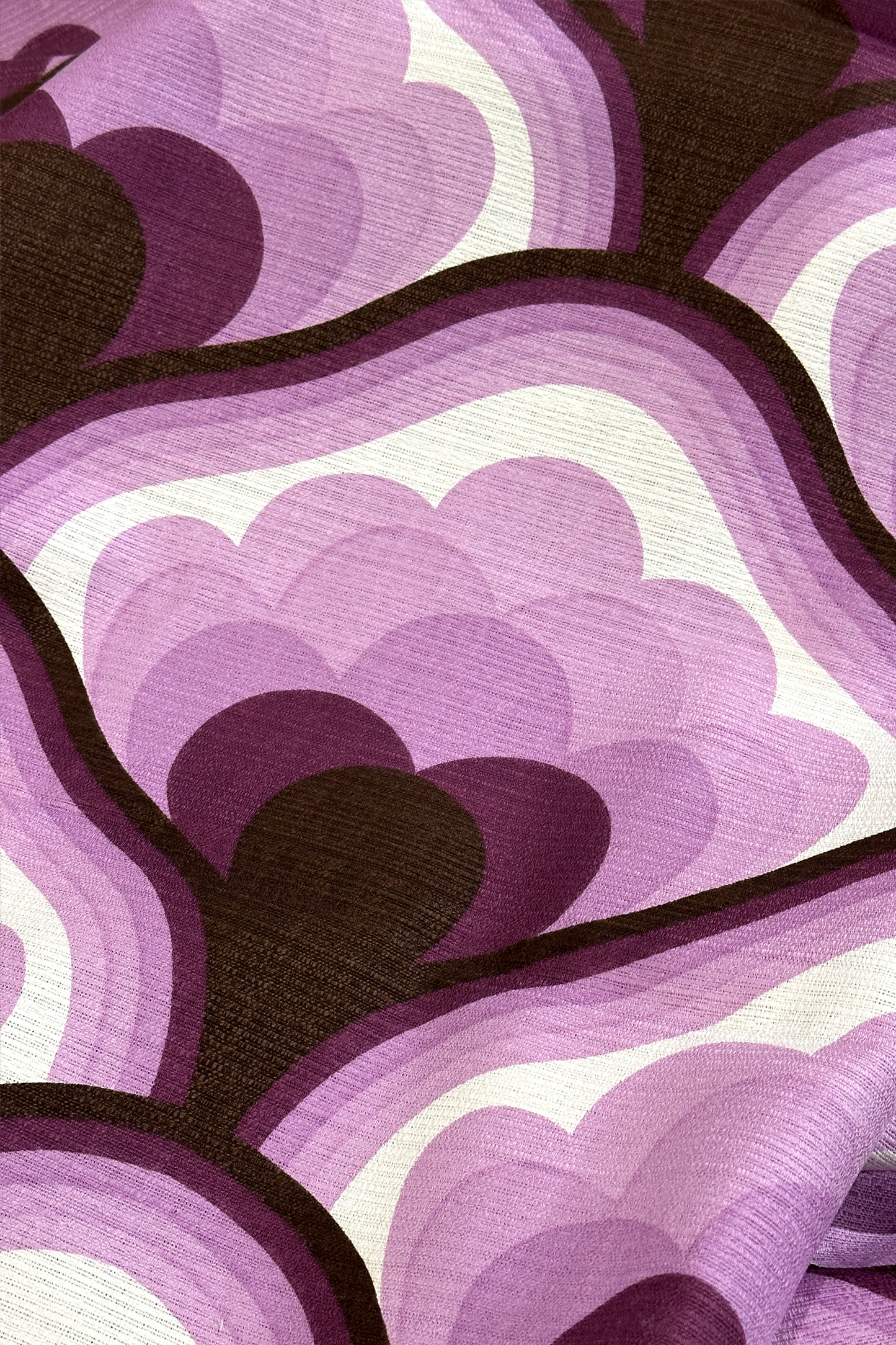 Viola - Close-up of viola vintage fabric with purple, brown, and white geometric pattern