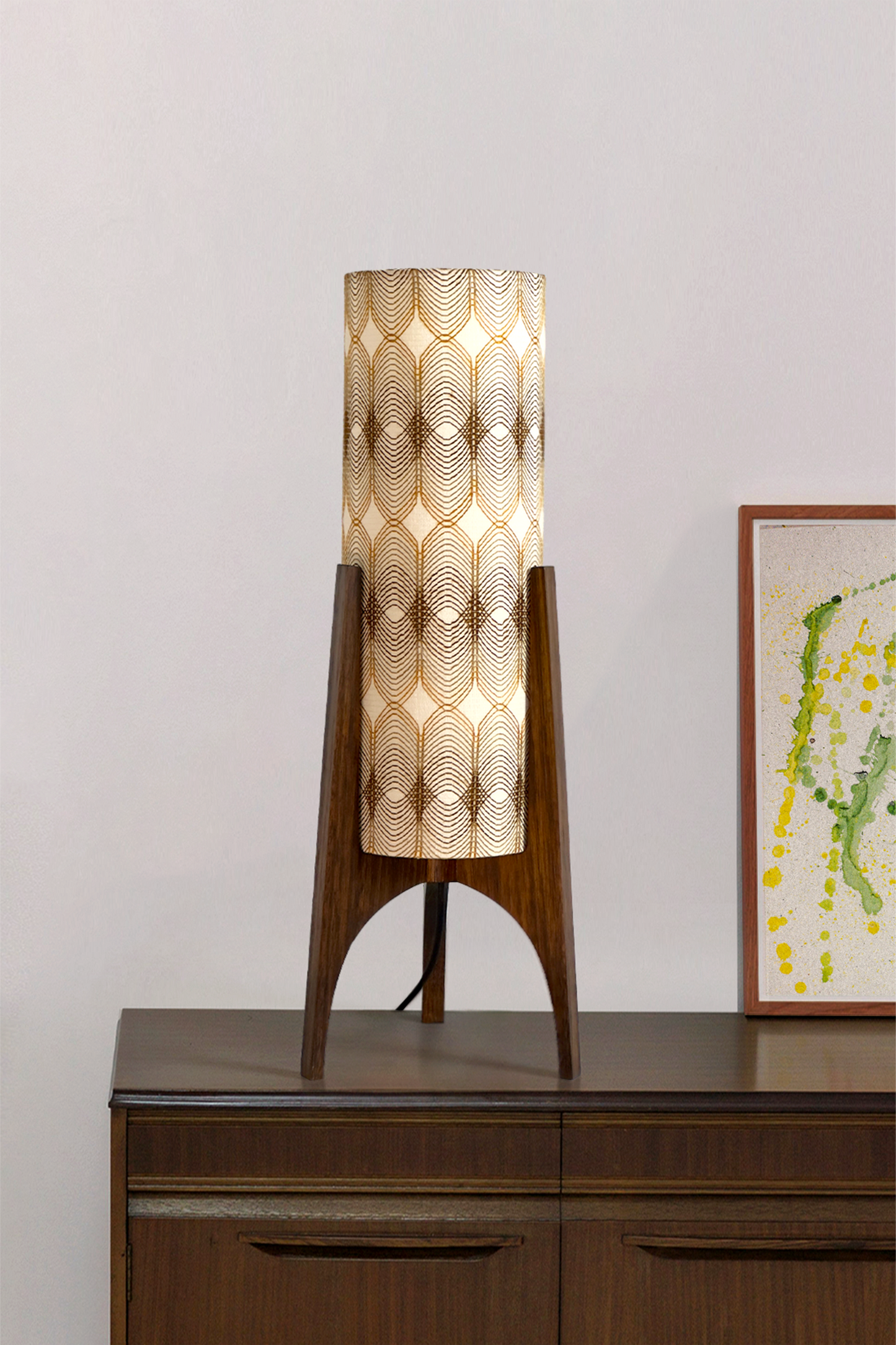 Noa - Archie Rocket Table lamp with a vintage woven fabric shade on a wooden cabinet against a white wall.