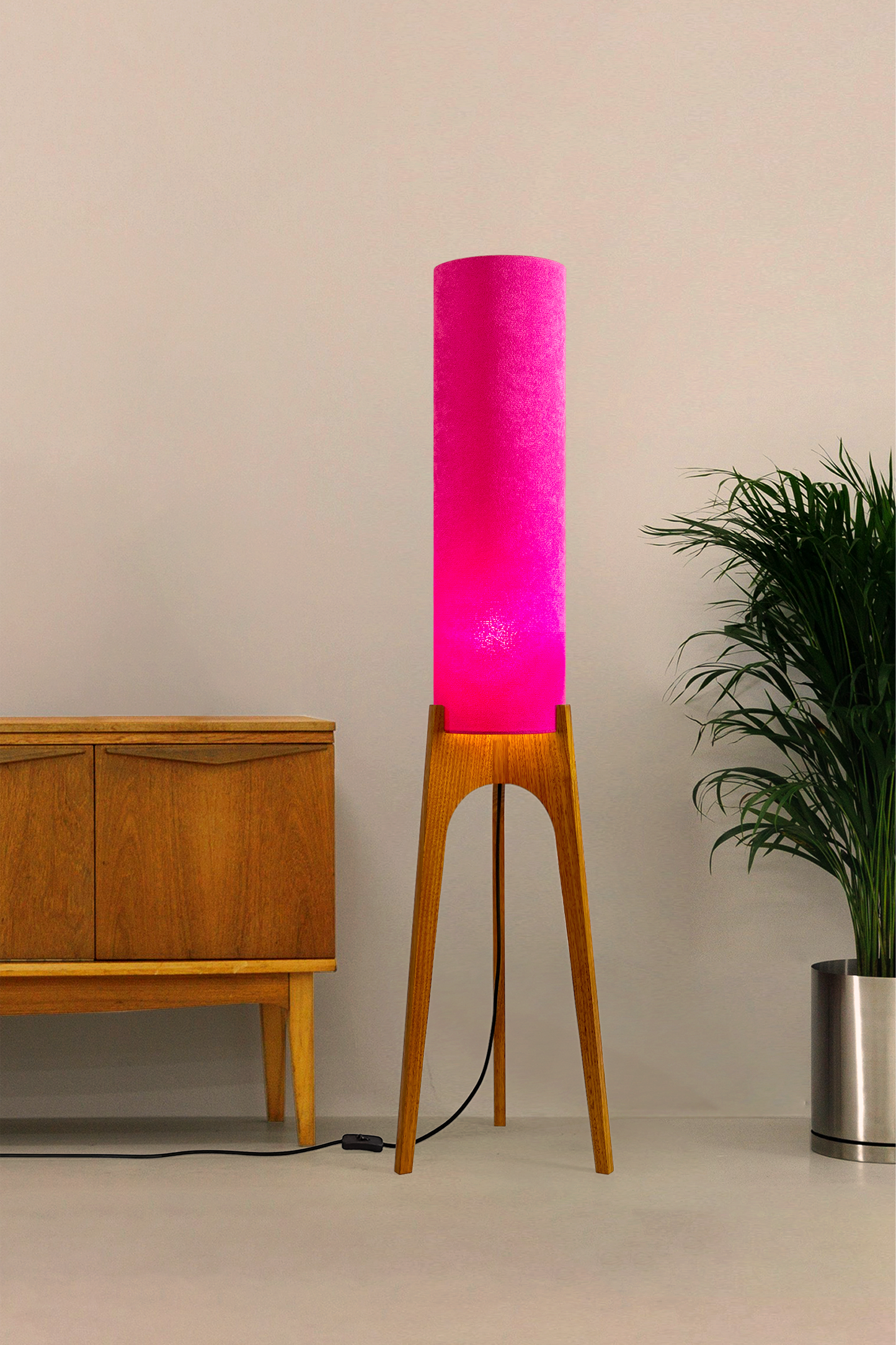 Pink Archie Rocket Floor Lamp made from recycled fabric and a wooden lamp base in a mid-modern century room.