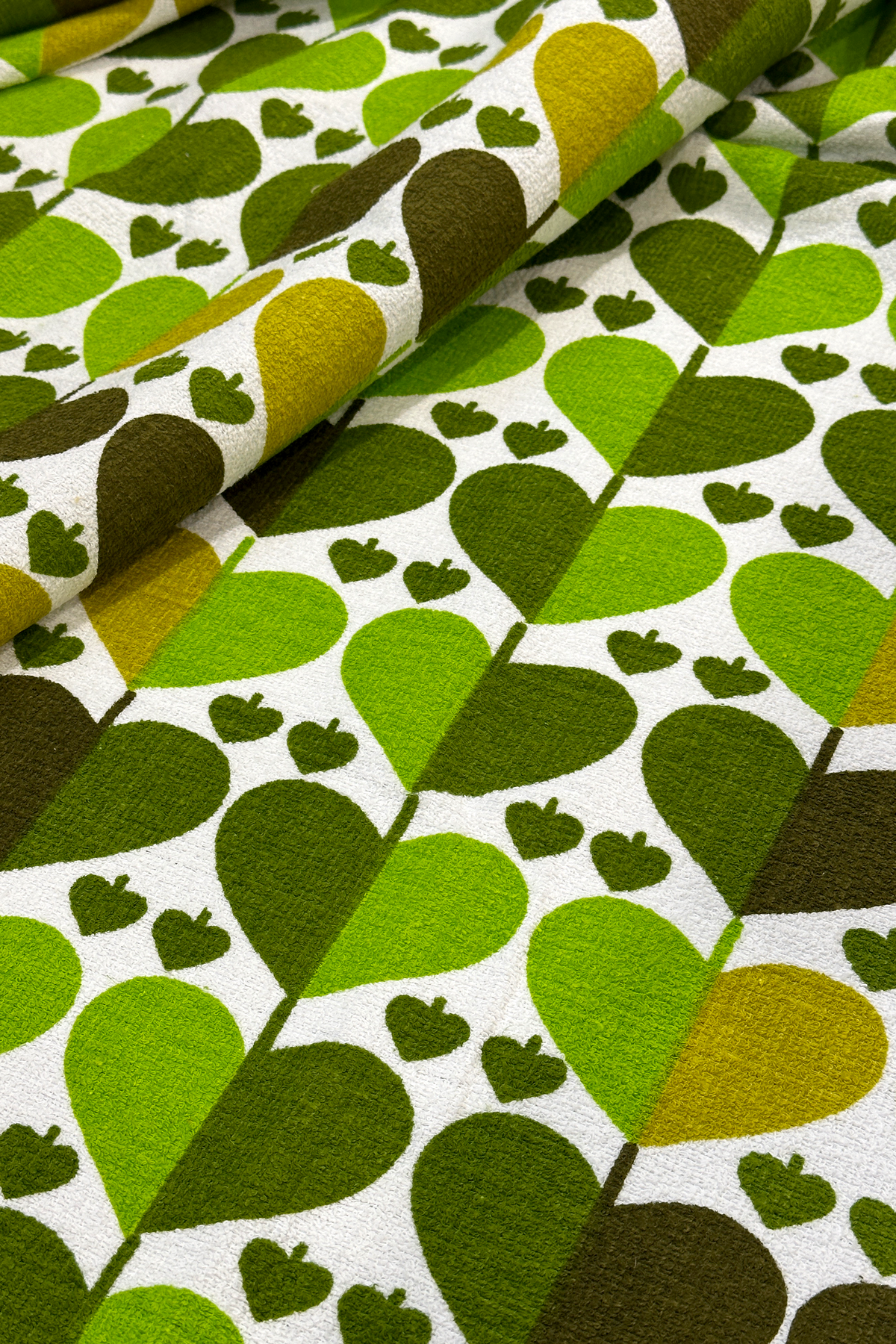 Alfie - authentic vintage geometric fabric with heart-like motif in shades of apple green, moss and warm forest green 