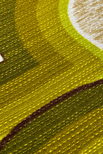 Close up of Asher vintage fabric with green and brown tones, and fabric textures