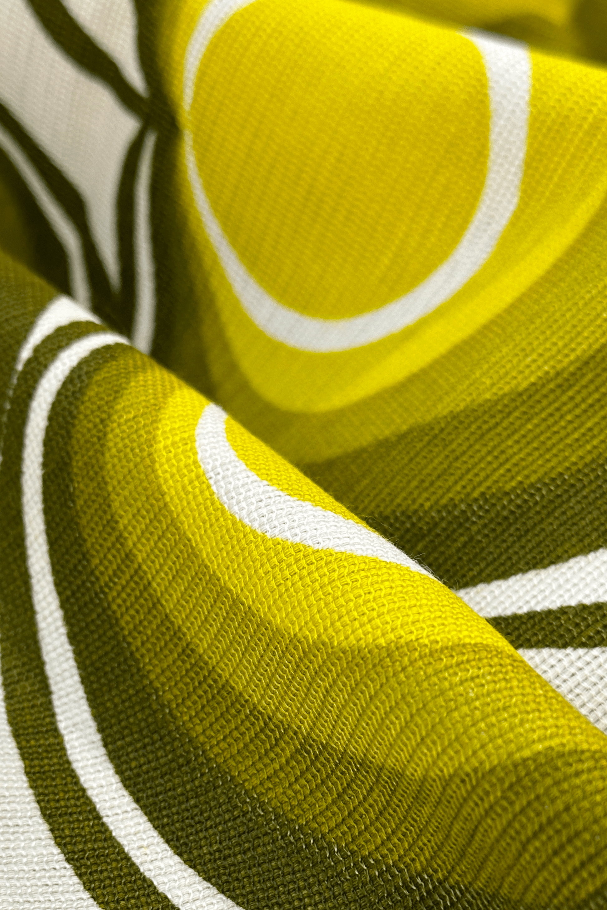 Close-up of fabric with green, yellow, and white pattern