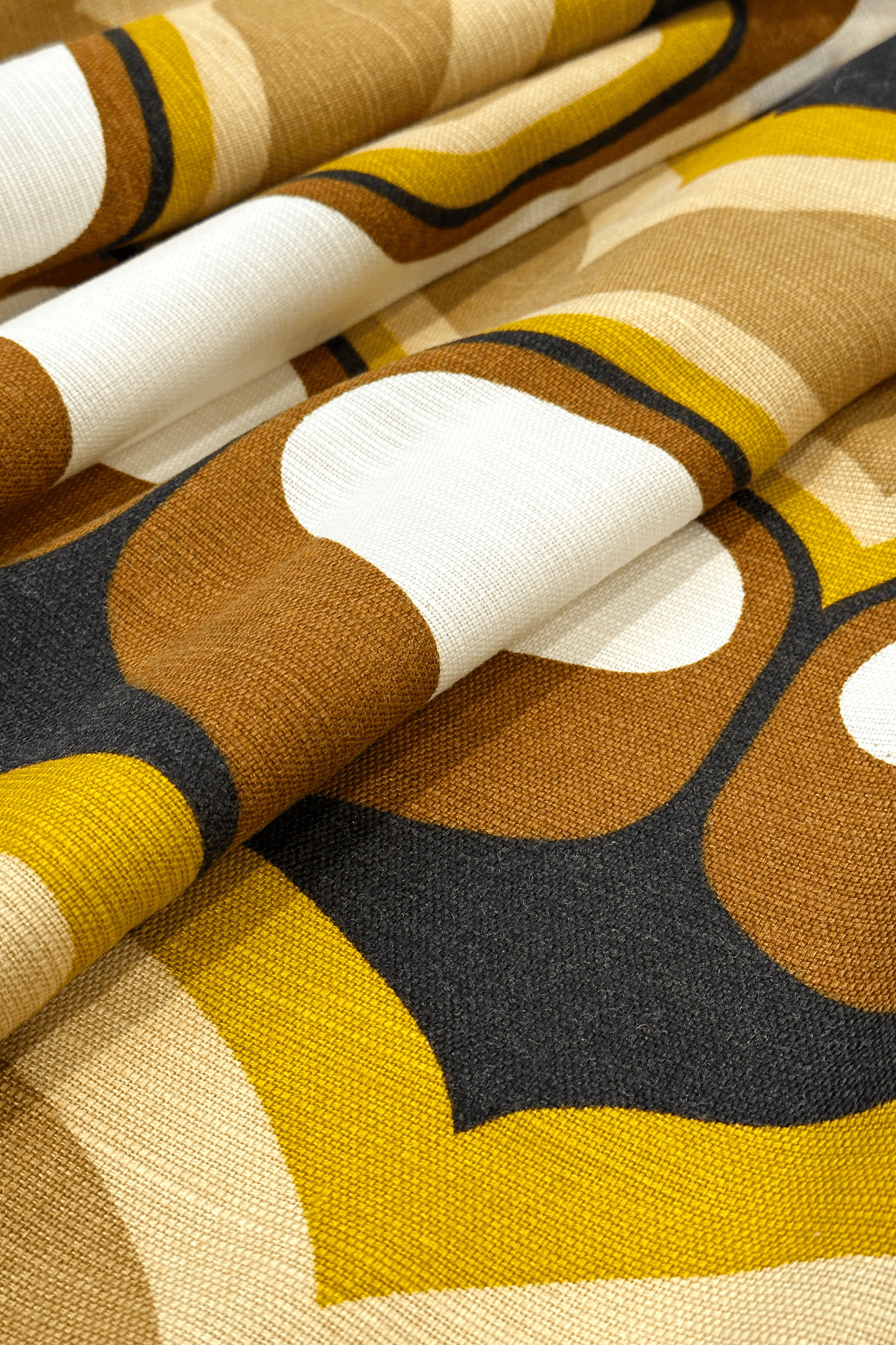 Bruno - Close-up of patterned vintage geometric fabric with brown, yellow, and white colors.