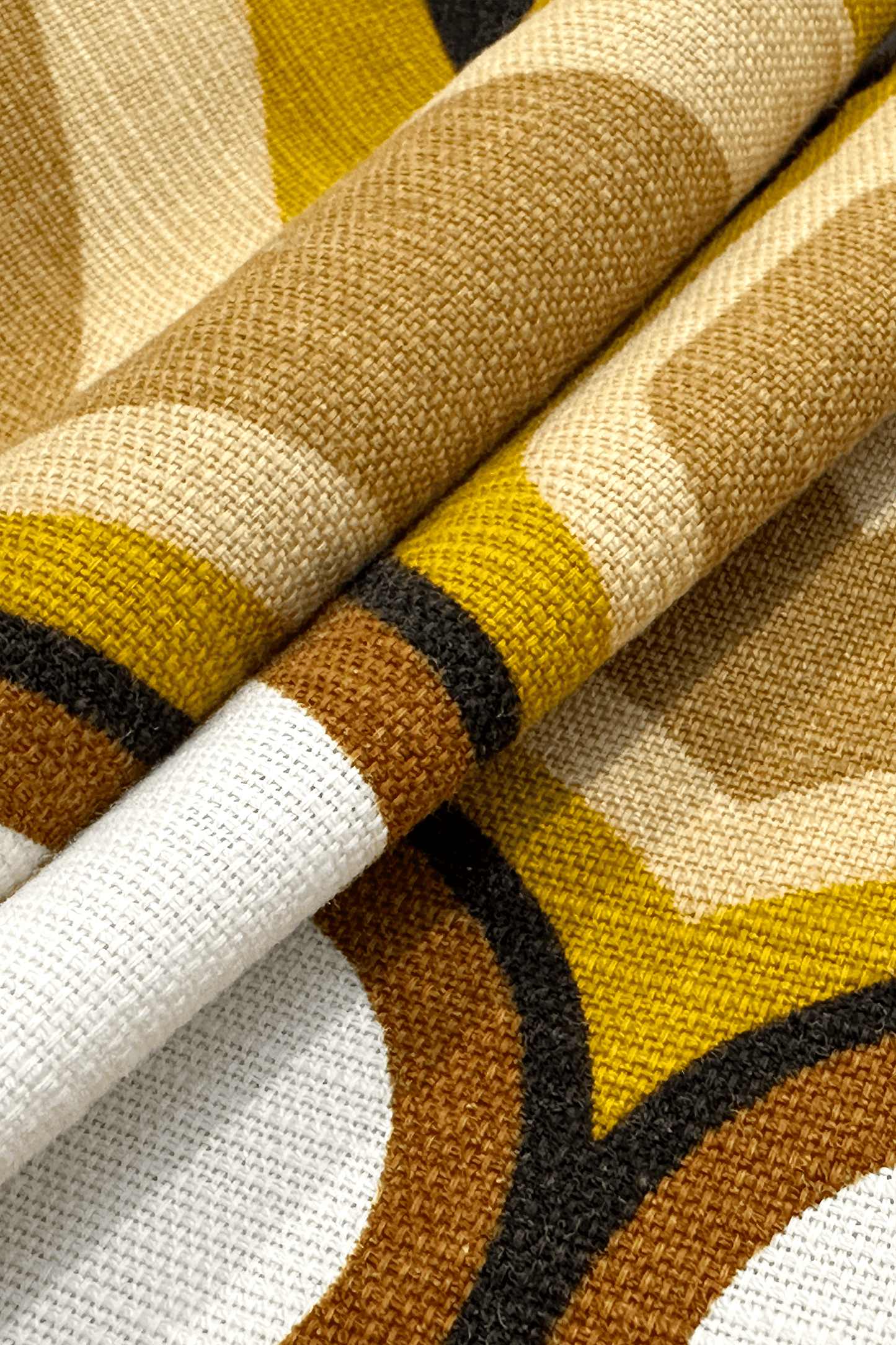 Bruno - Close-up of patterned vintage geometric fabric with brown, yellow, and white colors.