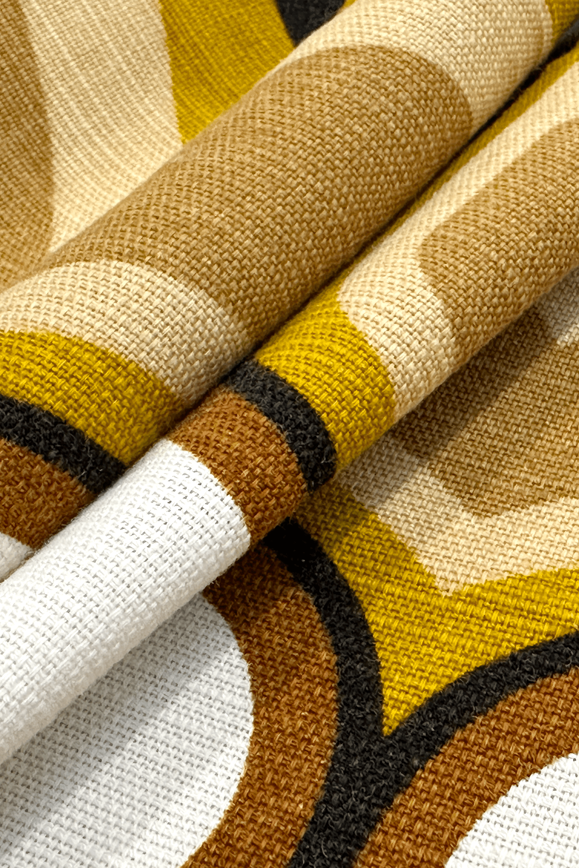 Bruno - Close-up of patterned vintage geometric fabric with brown, yellow, and white colors.
