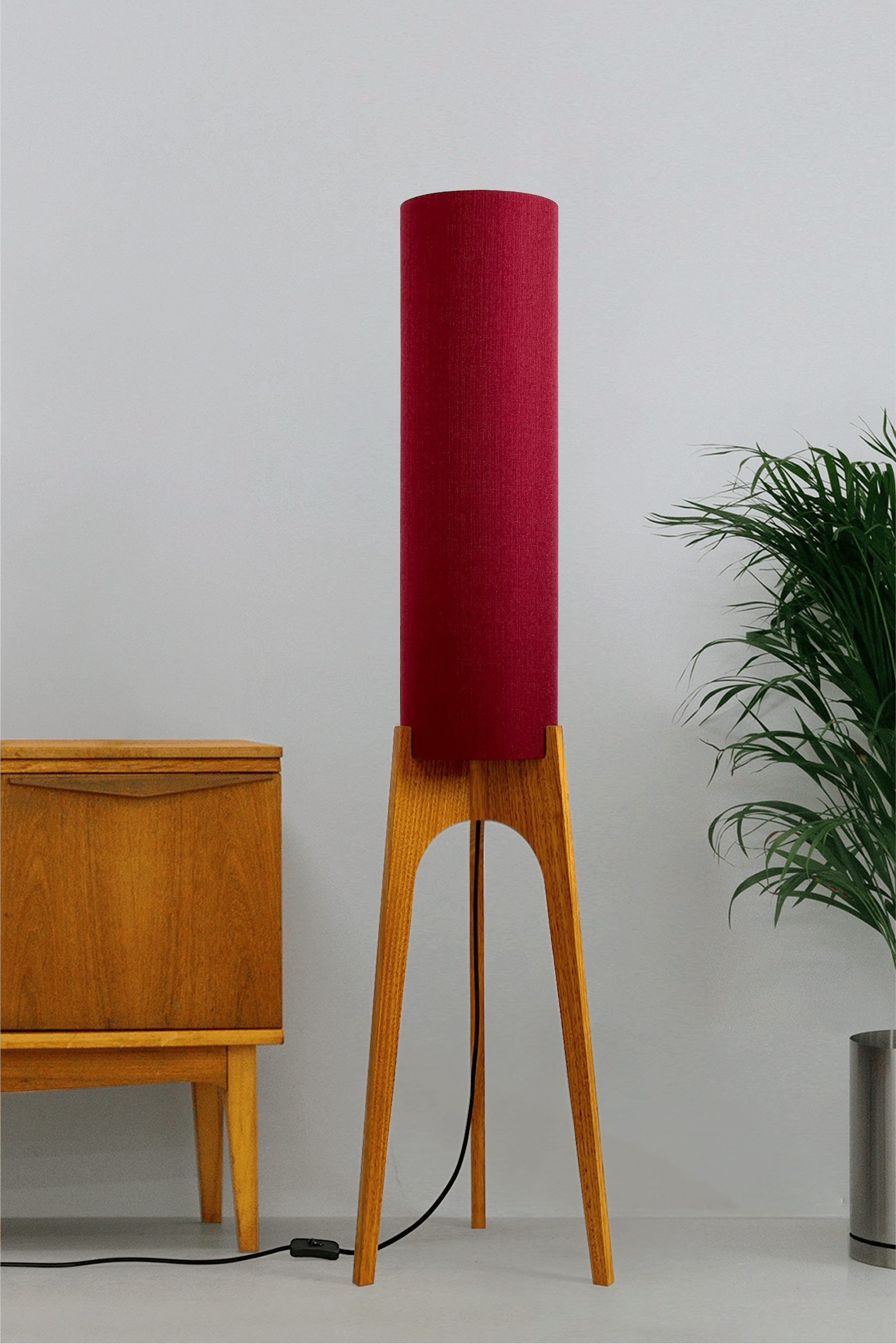Wooden rocket floor lamp with a Burgundy cylindrical lampshade handmade from recycled fabric, on a neutral background