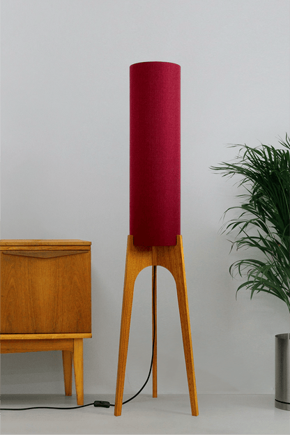 Wooden rocket floor lamp with a Burgundy cylindrical lampshade handmade from recycled fabric, on a neutral background