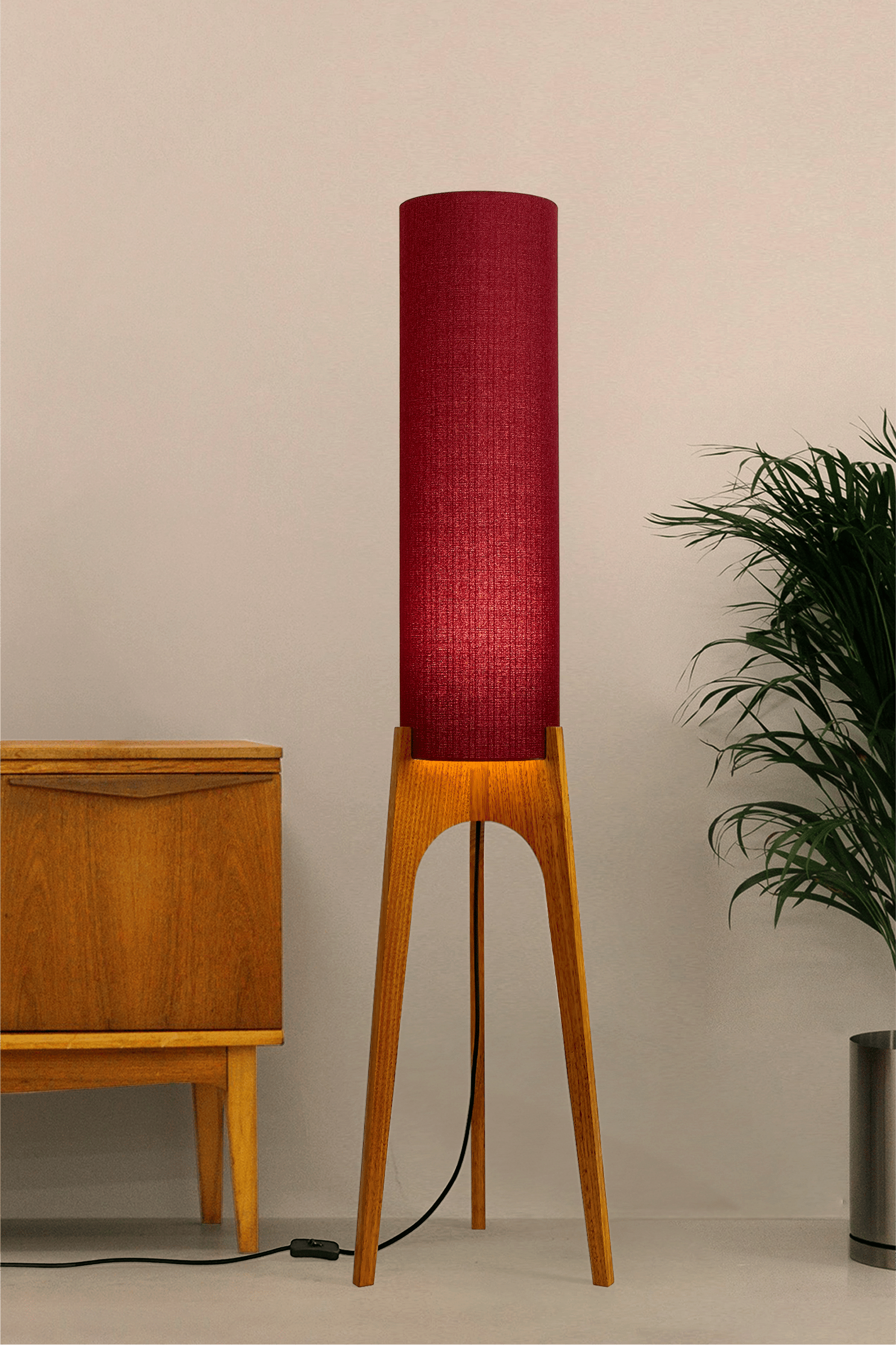 Wooden rocket floor lamp with a Burgundy cylindrical lampshade handmade from recycled fabric, on a neutral background