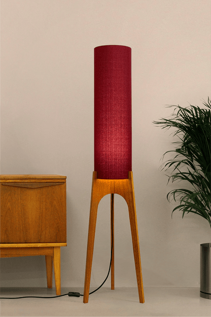 Wooden rocket floor lamp with a Burgundy cylindrical lampshade handmade from recycled fabric, on a neutral background