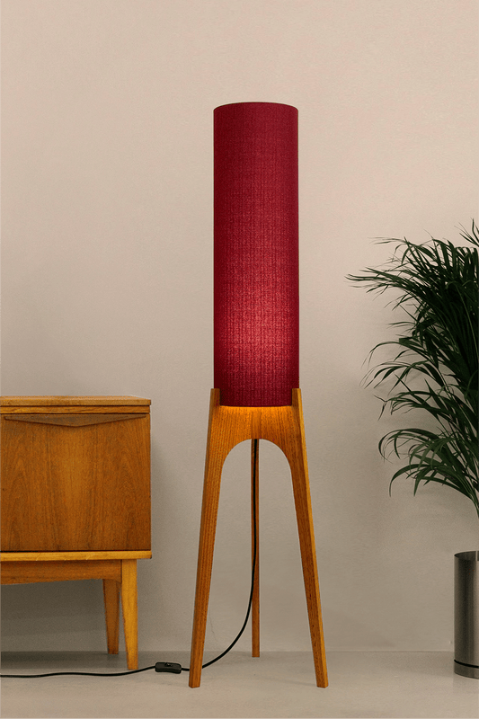 Wooden rocket floor lamp with a Burgundy cylindrical lampshade handmade from recycled fabric, on a neutral background