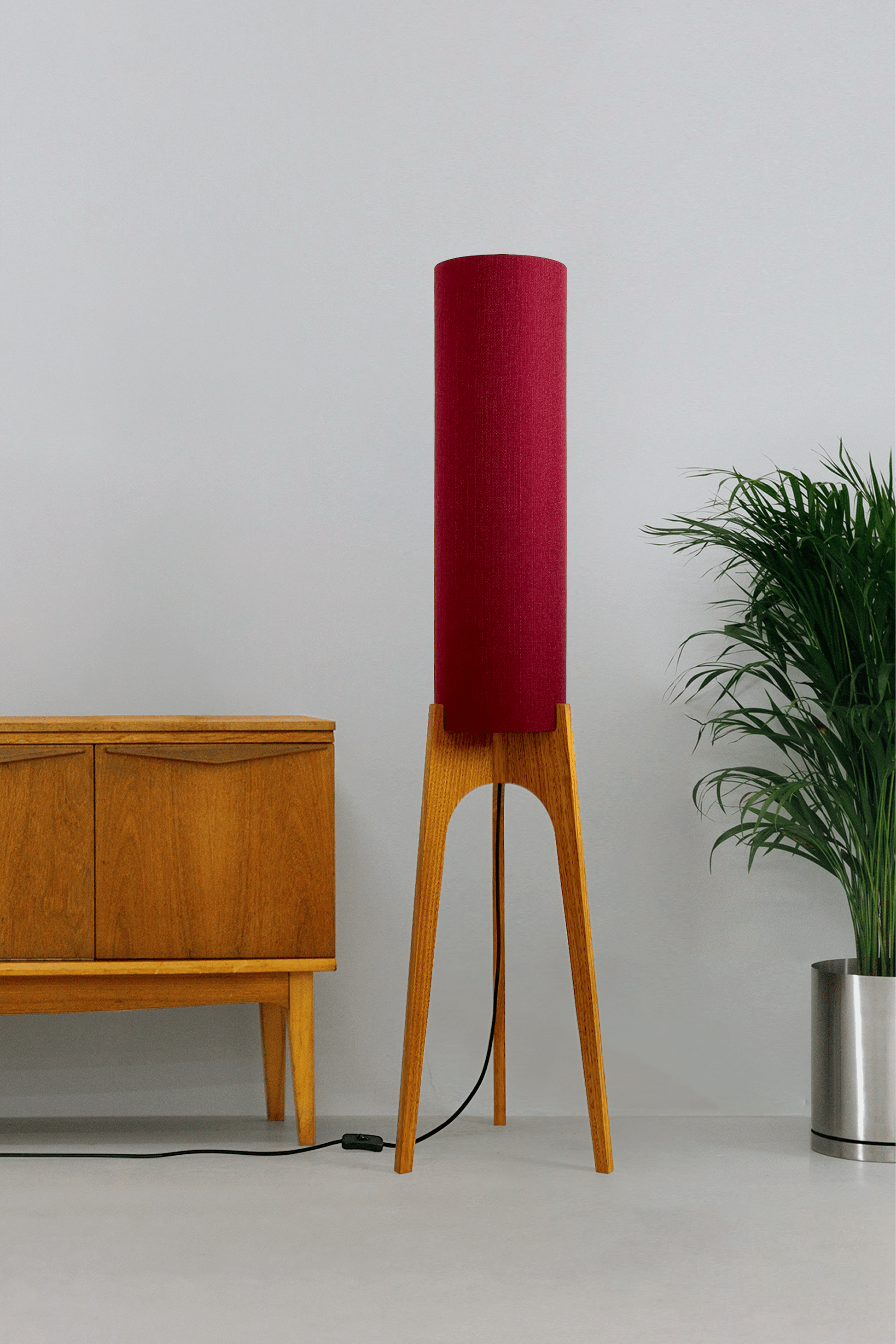 Wooden rocket floor lamp with a Burgundy cylindrical lampshade handmade from recycled fabric, on a neutral background