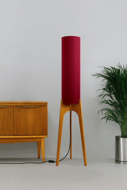 Wooden rocket floor lamp with a Burgundy cylindrical lampshade handmade from recycled fabric, on a neutral background