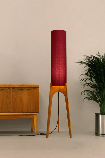 Wooden rocket floor lamp with a Burgundy cylindrical lampshade handmade from recycled fabric, on a neutral background