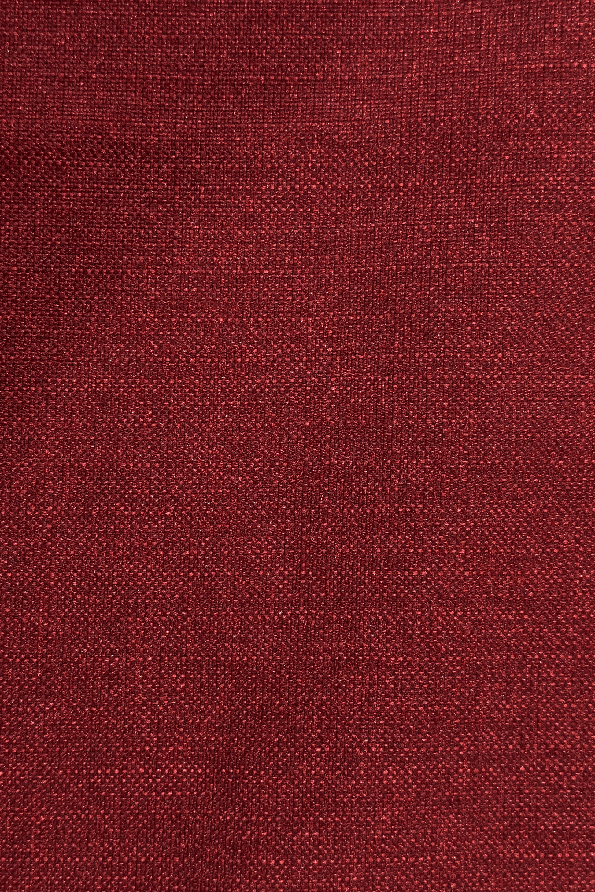 Close-up of a red burgundy textured red fabric surface
