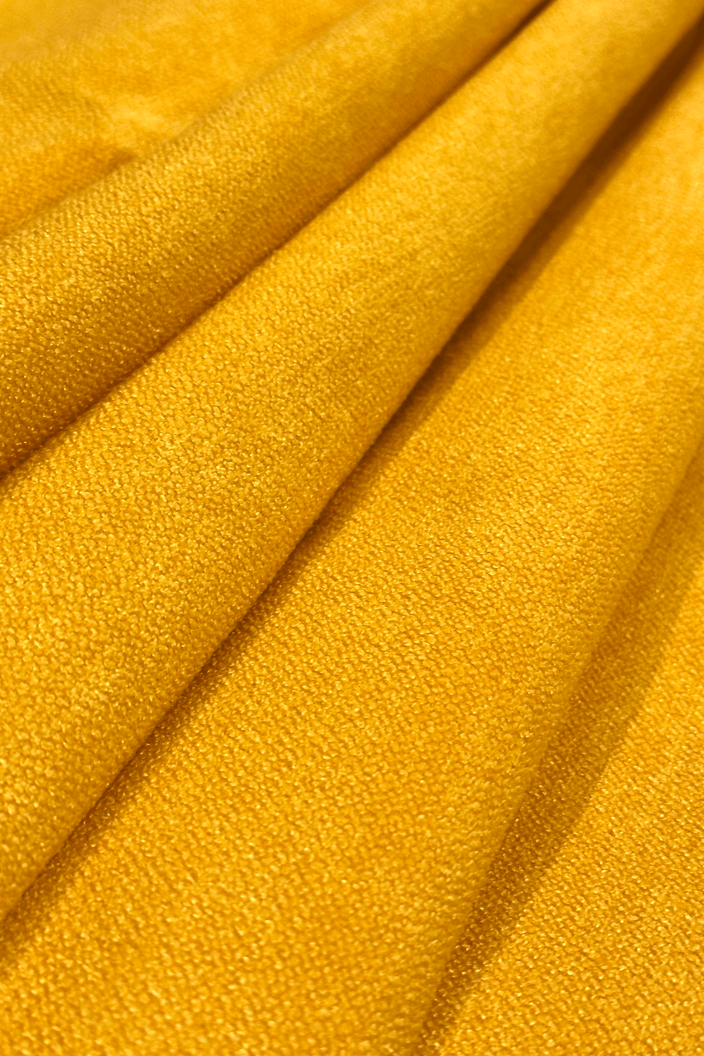 Close-up of canary yellow fabric with folds