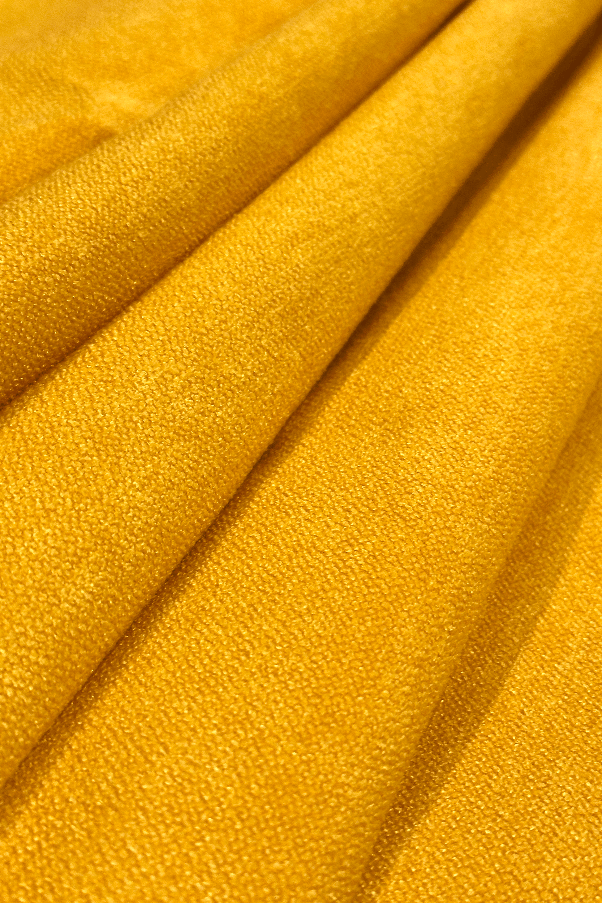 Close-up of canary yellow fabric with folds