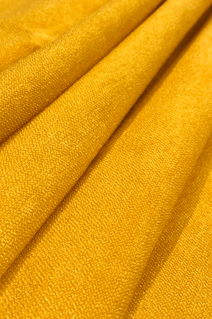 Close-up of canary yellow fabric with folds