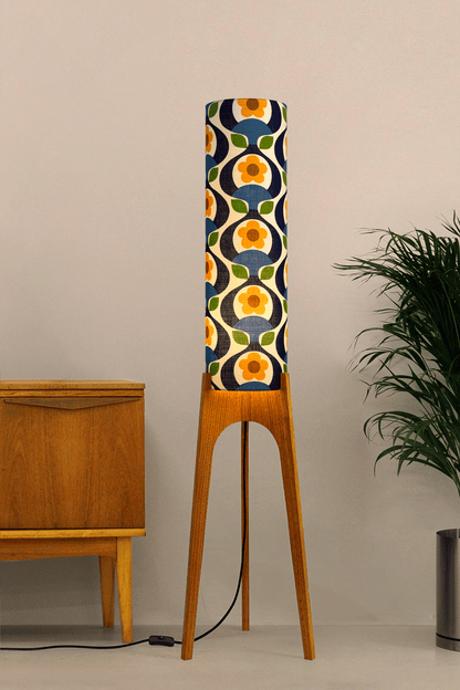 Wooden rocket floor lamp with a colourful geometric patterned lampshade handmade from authentic 70's vintage fabric on a plain background