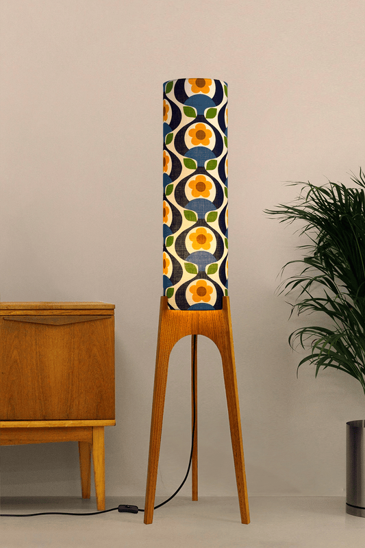 Wooden rocket floor lamp with a colourful geometric patterned lampshade handmade from authentic 70's vintage fabric on a plain background