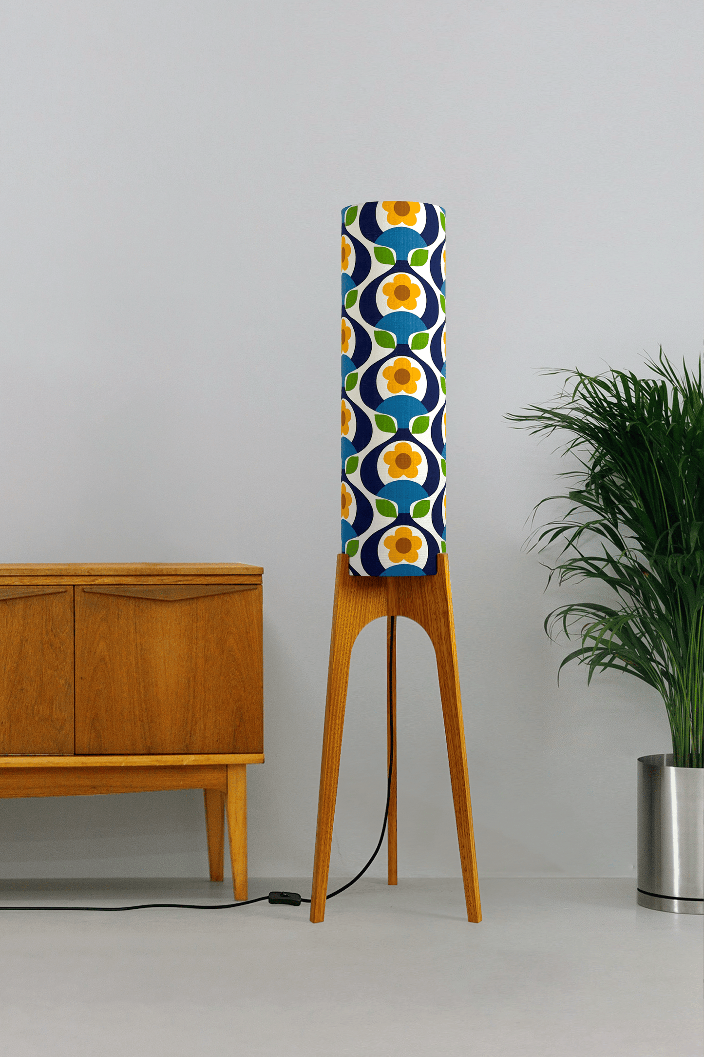 Wooden rocket floor lamp with a colourful geometric patterned lampshade handmade from authentic 70's vintage fabric on a plain background