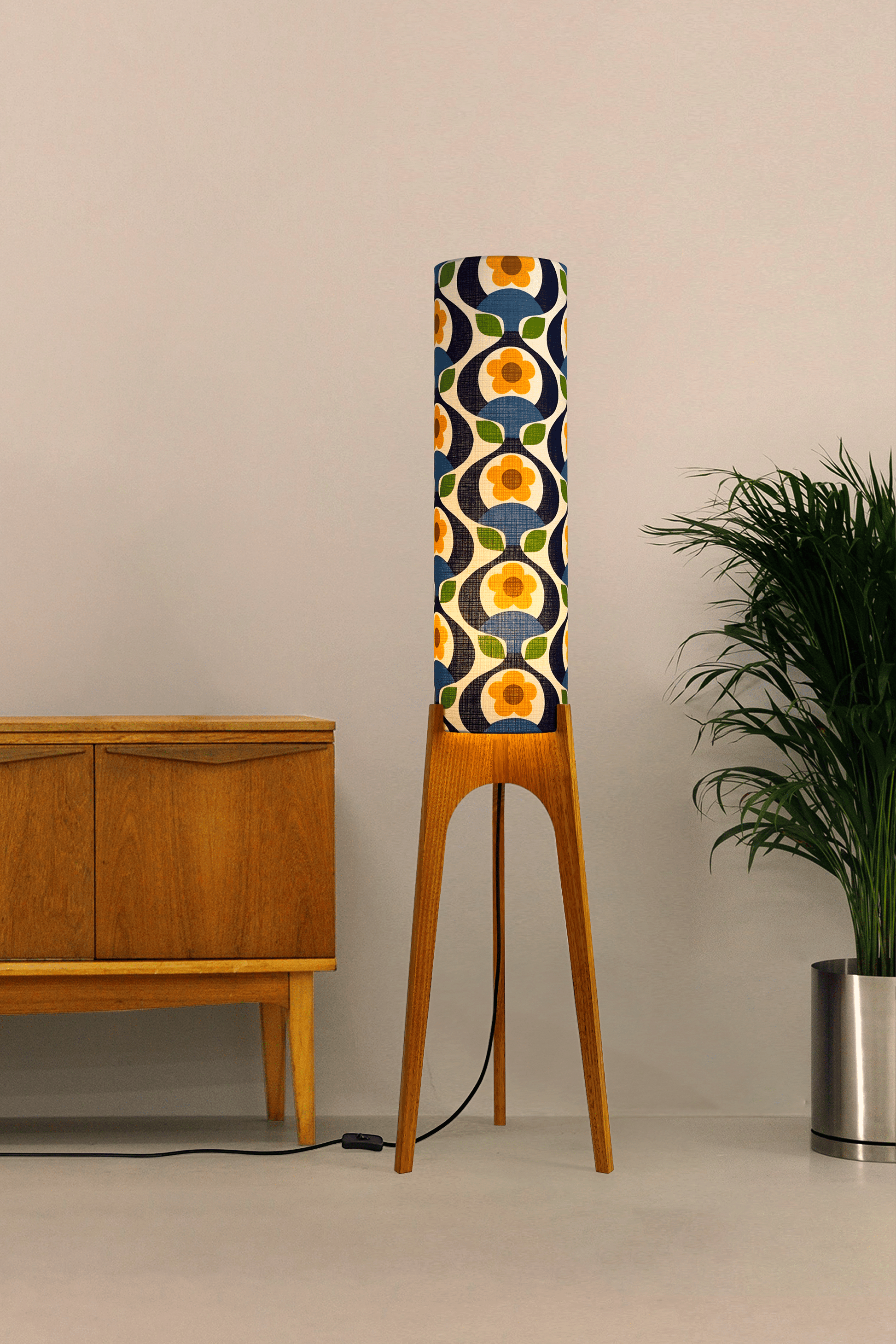 Wooden rocket floor lamp with a colourful geometric patterned lampshade handmade from authentic 70's vintage fabric on a plain background