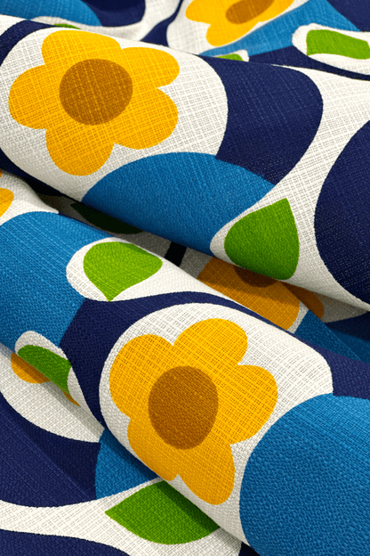 Close-up of fabric with colorful floral pattern featuring blue, yellow, green, and brown.