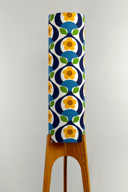 Wooden rocket floor lamp with a colourful geometric patterned lampshade handmade from authentic 70's vintage fabric on a plain background