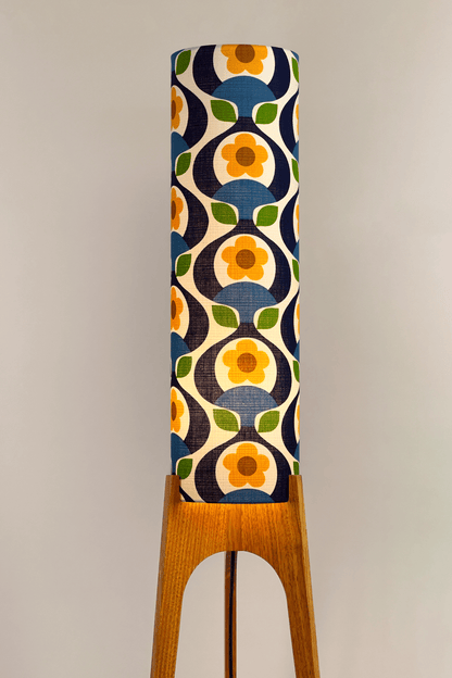Wooden rocket floor lamp with a colourful geometric patterned lampshade handmade from authentic 70's vintage fabric on a plain background