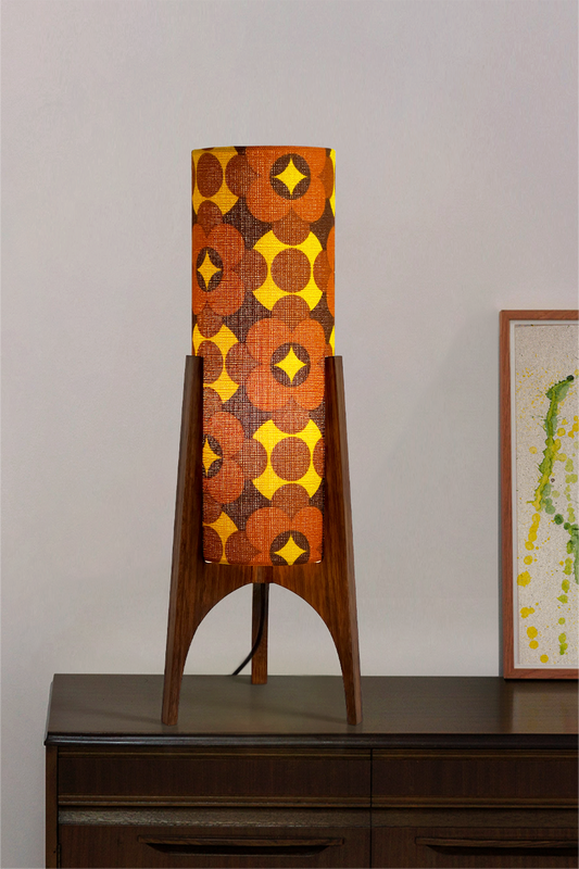 Coco - Archie Rocket Table lamp with a vintage geometric patterned fabric shade on a wooden cabinet against a white wall.