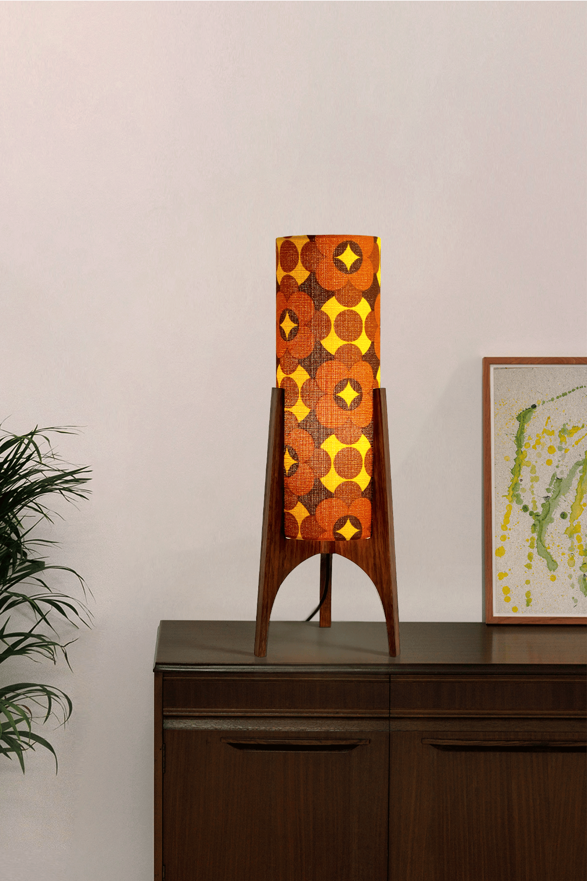 Coco - Archie Rocket Table lamp with a vintage geometric patterned fabric shade on a wooden cabinet against a white wall.