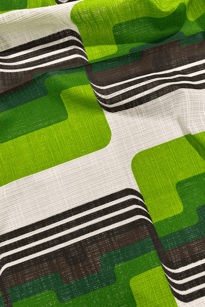 Close-up of fabric with green, brown, and white geometric pattern