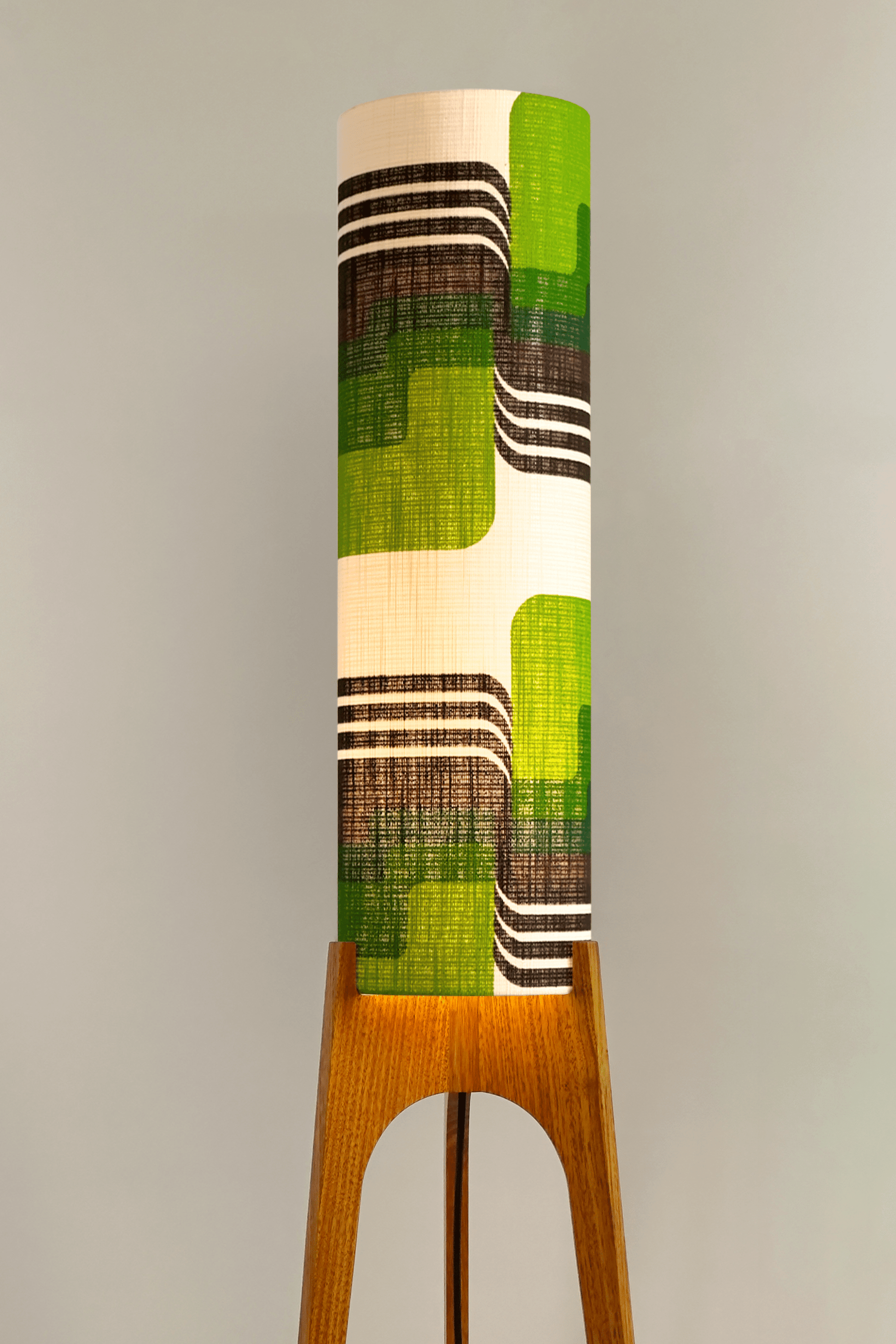 Fern - Archie Rocket floor lamp with handmade wooden base and handcrafted lampshade from vintage fabric with retro geometric patterns in green, brown, and white.