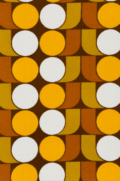 Vintage terry cloth fabric featuring egg-yolk yellow, mustard, warm brown, and soft cream tones, the pattern brings together rhythmic circles and curved geometric forms