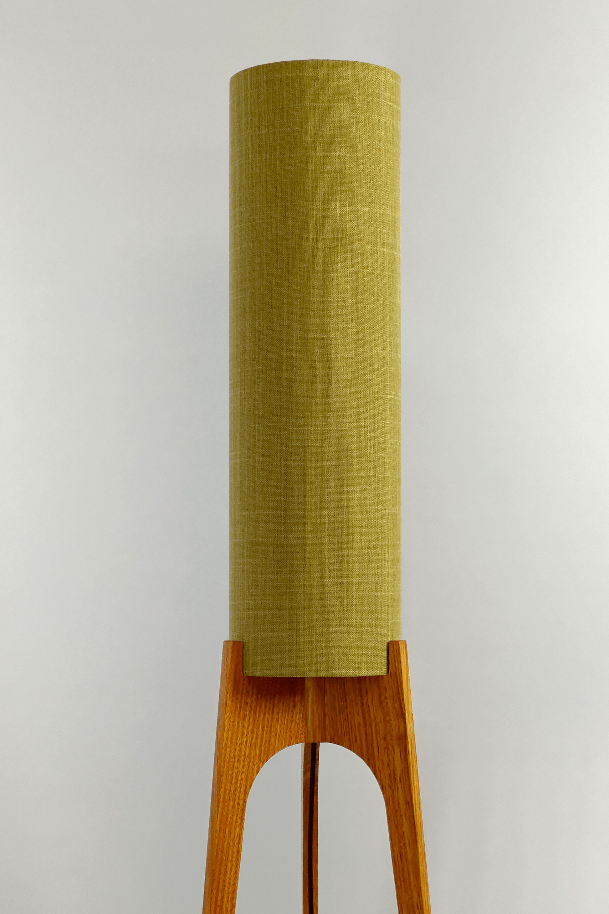Archie Rocket Floor Lamp with lemongrass cylindrical shade on a wooden base against a white background