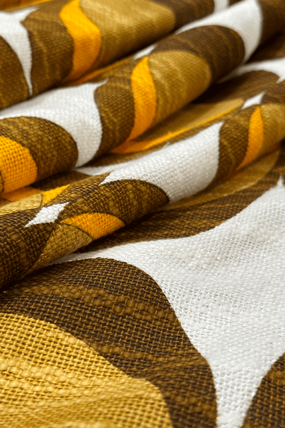 authentic 1970s vintage woven fabric, featuring a flowing retro pattern in chocolate brown, caramel and orange.