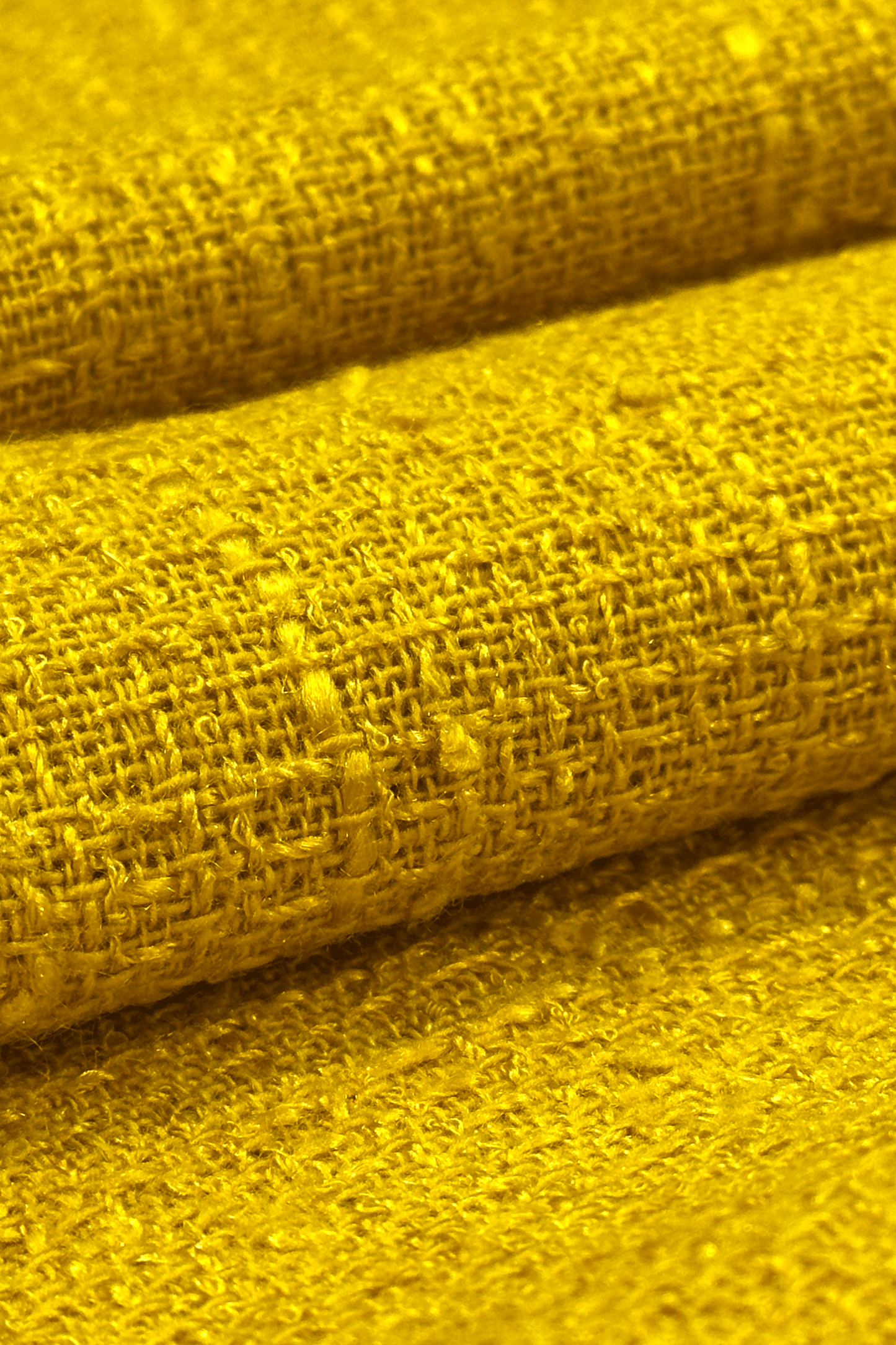 Close-up of yellow fabric with a textured pattern